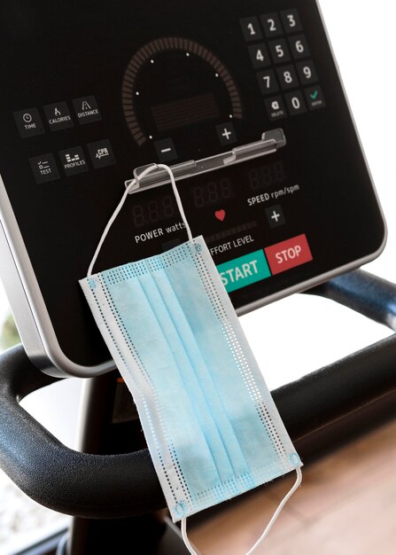 medical mask on gym equipment