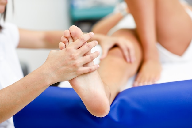 Medical massage at the foot in a physiotherapy center.