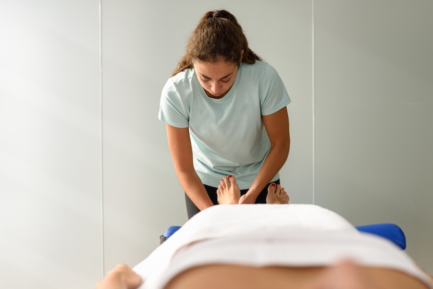 Medical massage at the foot in a physiotherapy center.