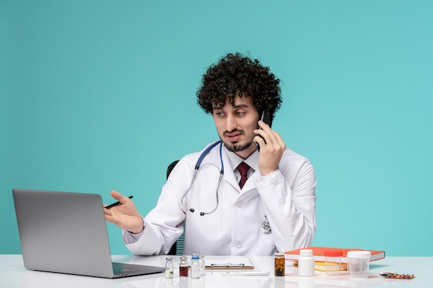 Medical serious cute handsome doctor working on computer in lab coat on the call