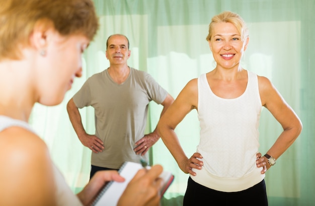 Medical staff with senior people at gym