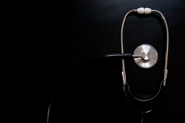 Free photo medical stethoscope isolated with black background. medical concept. stethoscope on black background with space for text - health concept. medical conceptual