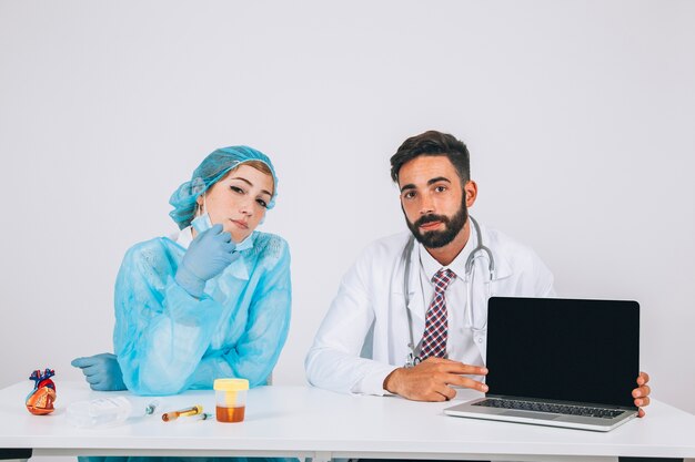 Medical team posing with laptop's screen