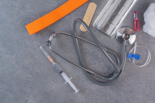 Medical tools placed on marble table.