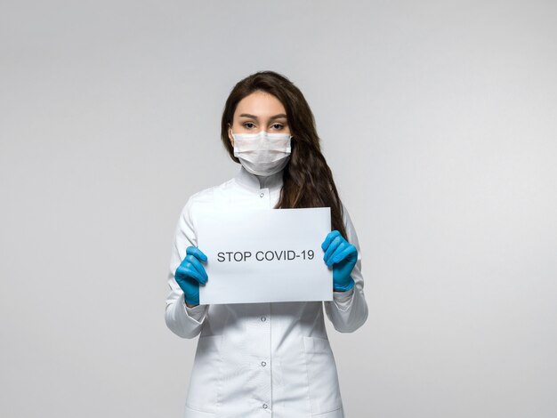 Medical worker holding paper with message