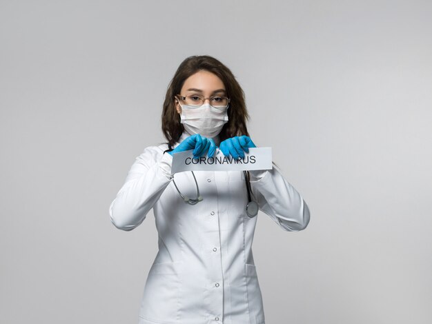 Медицинский работник разрывает коронавирусную бумагу