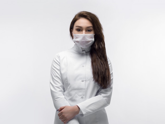 Medical worker in white doctor uniform and white protective mask