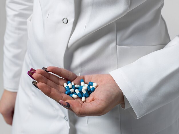 Medical worker with lots of pills in her hand