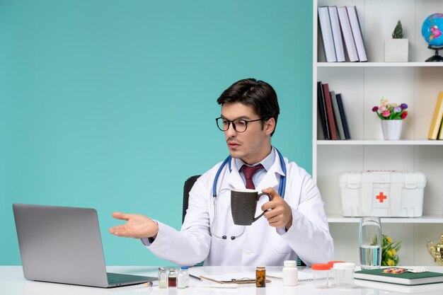 환자와 대화하는 컴퓨터에서 원격으로 작업하는 실험실 코트를 입은 의료 젊은 똑똑한 의사