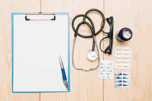 Free photo medications and stethoscope near clipboard and glasses