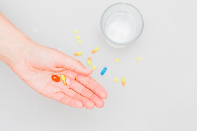 Medicine concept with pills and hand