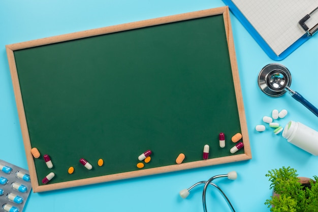  of medicine, supplies placed on a green board coupled with doctor tools on a blue  .