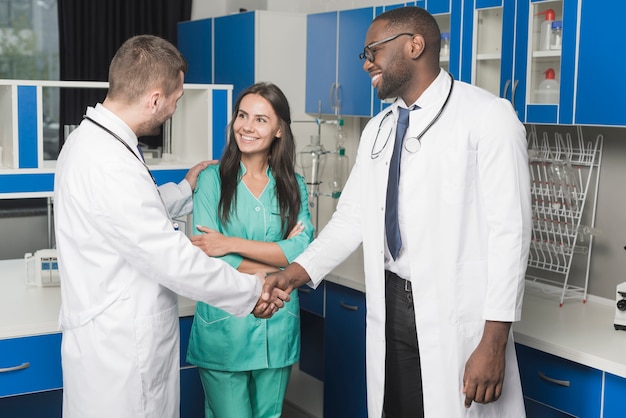 Medics handshaking in hospital