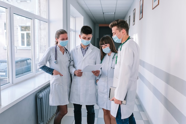 Medics in masks with papers