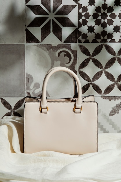 Free photo mediterranean aesthetic tiles with women's bag