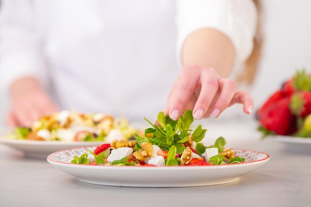 Mediterranean diet salad with feta cheese, grape, nuts, and lettuce.