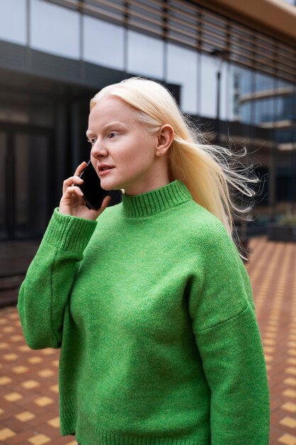 Medium shot albino woman talking on phone
