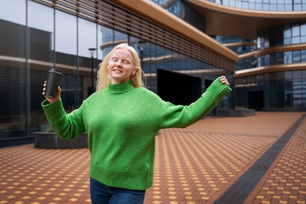 Medium shot albino woman with coffee cup