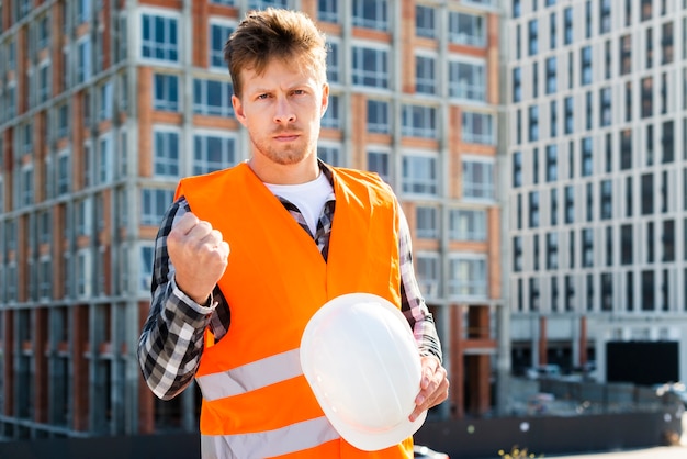 Medium shot of angry construction worker looking at camera