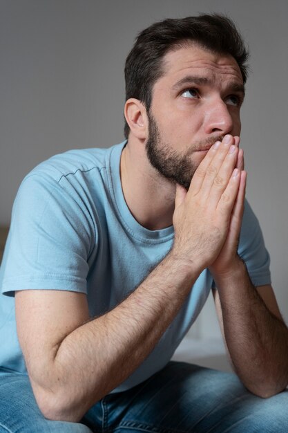 Medium shot anxious man praying