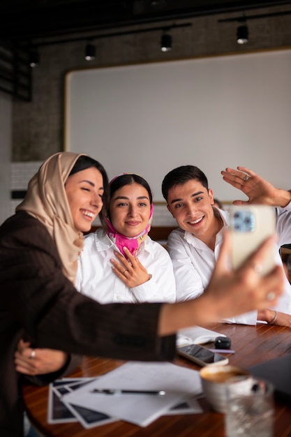 Medium shot arab friends taking selfie