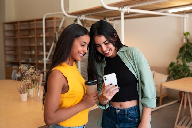 Free photo medium shot arab women with smartphone