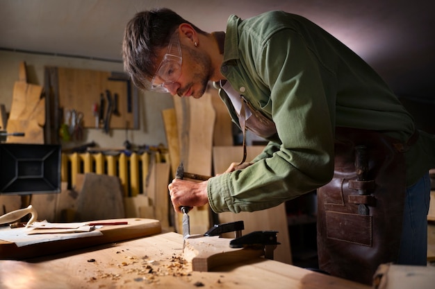 Medium shot artisan doing woodcutting