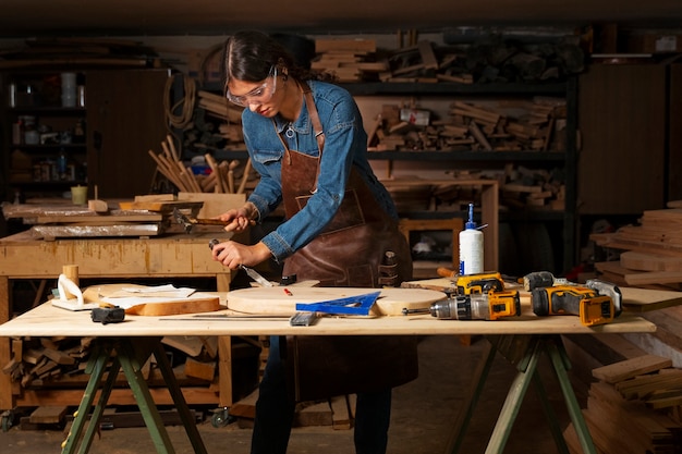 Medium shot artisan doing woodcutting