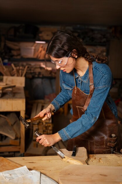 Medium shot artisan doing woodcutting