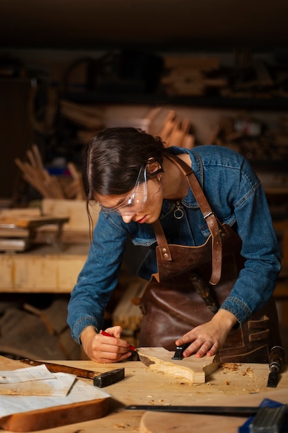 Free photo medium shot artisan doing woodcutting