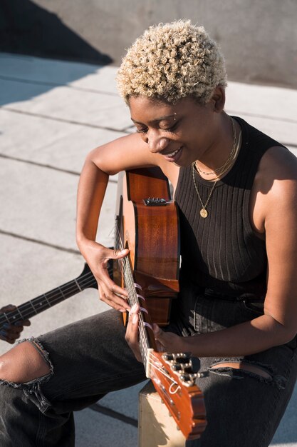 Medium shot artist playing the guitar