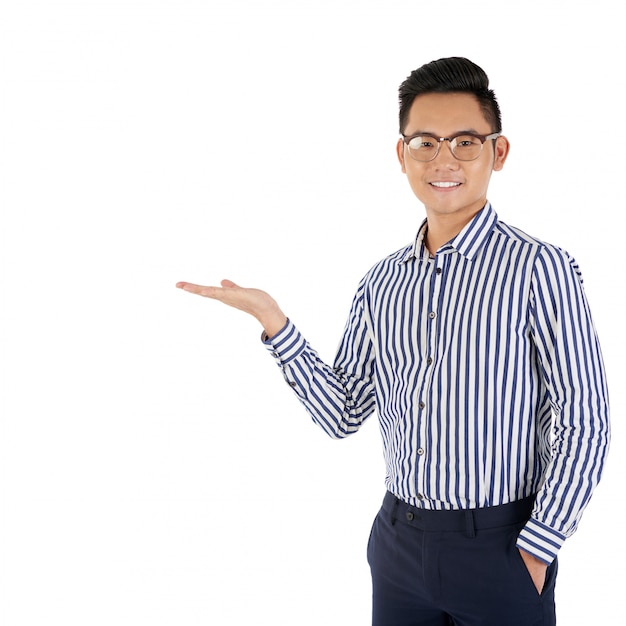 Medium shot of Asian man gesturing as if presenting a product 