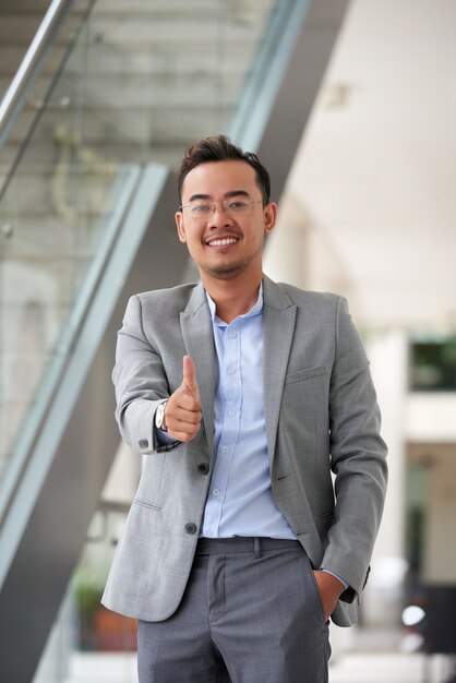 Free Photo medium shot of asian man giving a thumbs up gesture to the camera