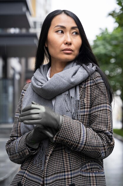 Medium shot asian model wearing gloves