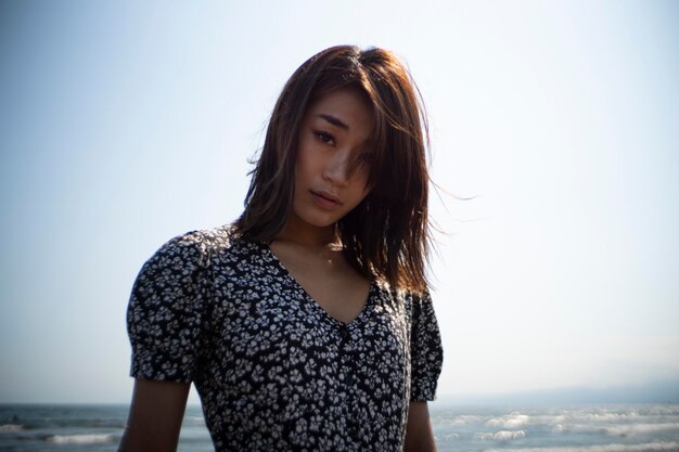 Medium shot asian woman at beach