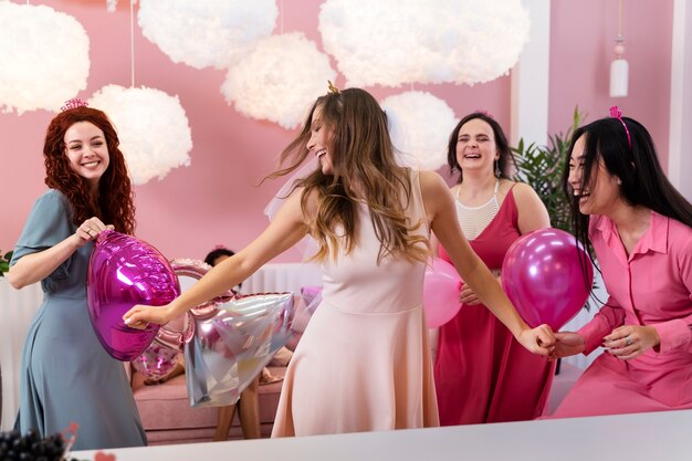 Medium shot bachelorette party with balloons