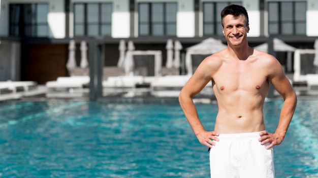 Medium shot of beautiful man at pool