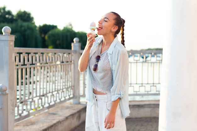 Medium shot beautiful woman eating an ice cream