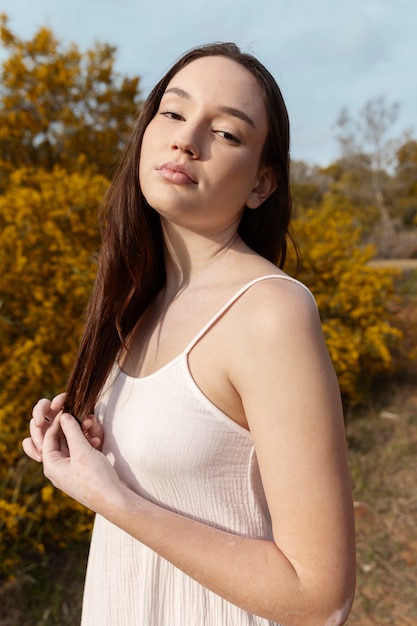 Medium shot beautiful woman in nature posing