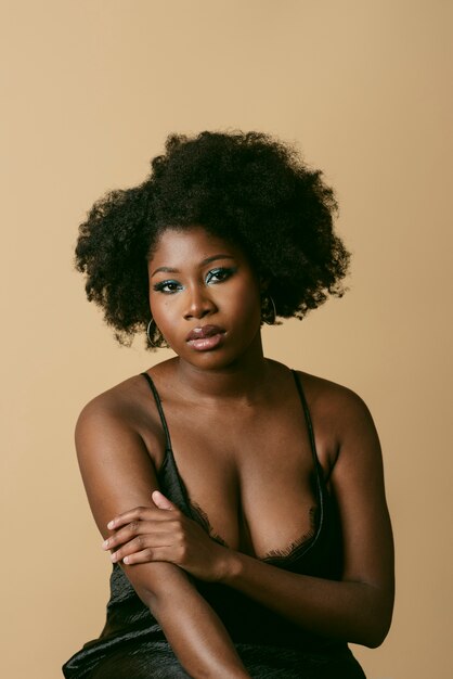 Medium shot black woman posing in studio