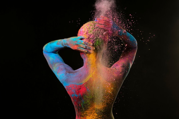 Medium shot black woman posing with colorful powder