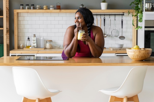 Medium shot black woman relaxing at home