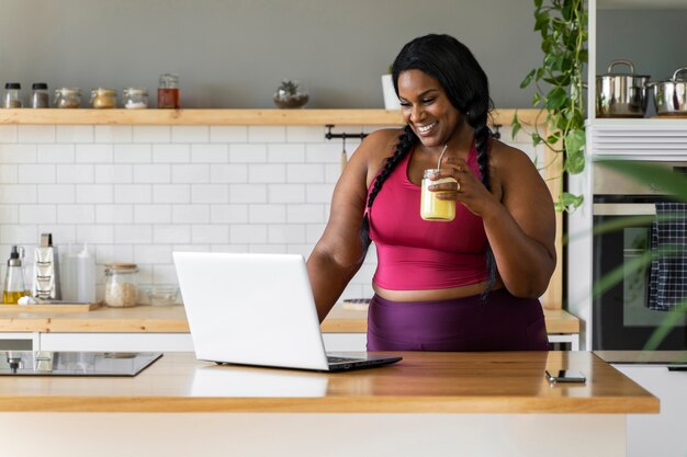 Medium shot black woman relaxing at home