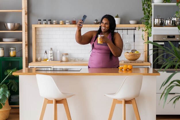 Medium shot black woman relaxing at home