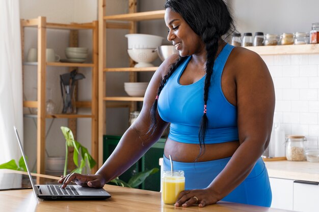 Free photo medium shot black woman relaxing at home