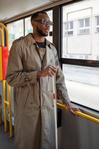 Medium shot blind man traveling by bus