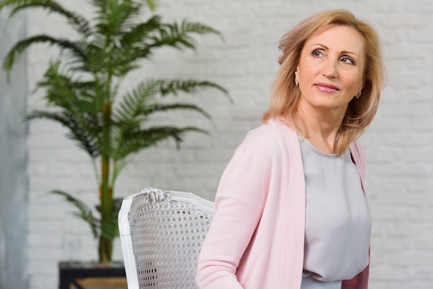 Medium shot blonde senior woman looking away