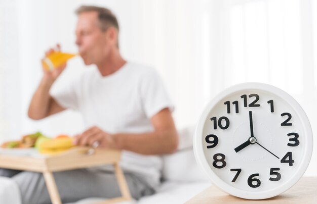 Medium shot blurred man having breakfast at 8 a.m.