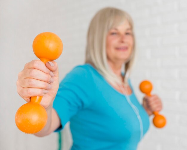 Medium shot blurred woman with dumbbells