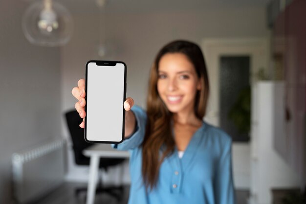 Medium shot blurry woman holding phone